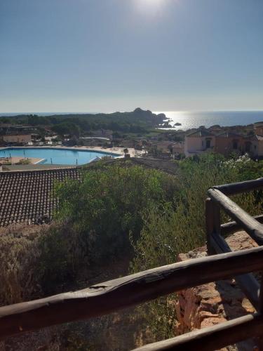 a view of the ocean from the balcony of a house at Appartamento Calarossa Sardegna CasaRosa in Isola Rossa