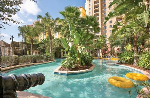 a swimming pool in a resort with palm trees at Wyndham Bonnet Creek 1BR Apartment with Resort Access in Orlando
