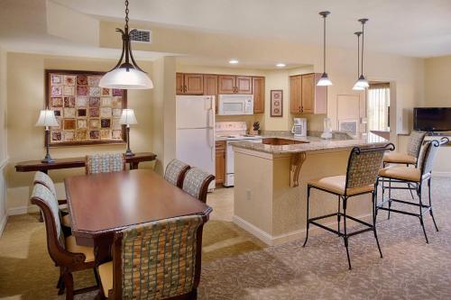 a kitchen and living room with a table and chairs at Wyndham Bonnet Creek 1BR Apartment with Resort Access in Orlando
