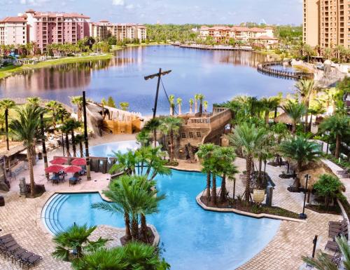 an aerial view of a resort pool with palm trees at Wyndham Bonnet Creek 1BR Apartment with Resort Access in Orlando