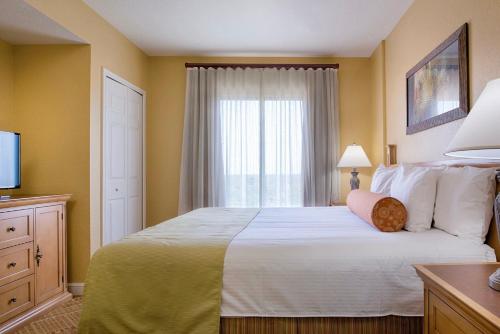 a bedroom with a large bed with a window at Wyndham Bonnet Creek 1BR Apartment with Resort Access in Orlando