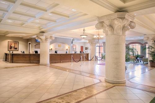 a large lobby with columns and a reception area at Wyndham Bonnet Creek 2BR Apartment with Resort Access in Orlando