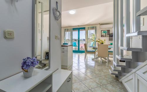 a kitchen and dining room with a view of the ocean at Marija Marković Medulin A15 in Medulin