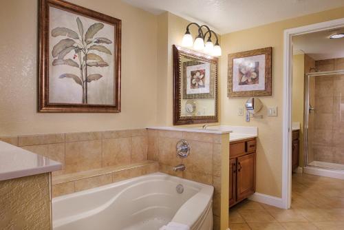a bathroom with a bath tub and a sink at Wyndham Bonnet Creek 2BR Apartment with Resort Access in Orlando