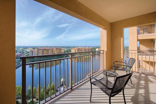 two chairs on a balcony with a view at Wyndham Bonnet Creek 2BR Apartment with Resort Access in Orlando