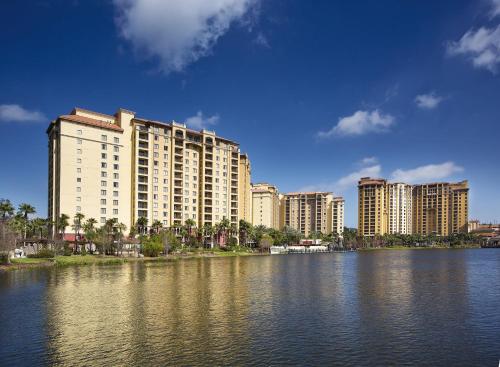 a large building next to a large body of water at Wyndham Bonnet Creek 3BR Apartment with Resort Access in Orlando