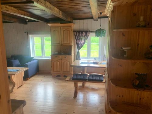 a kitchen with wooden cabinets and a wooden floor at Beautiful place among forests and fields in a good old style in Eggedal