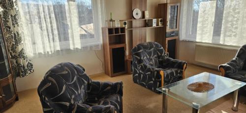 a living room with two chairs and a table at Apartmán Siuzen in Brezno