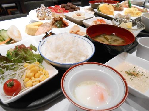 a table filled with different types of food at Hotel Crown Hills Sendai Aobadori in Sendai