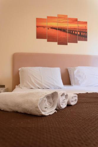 a bedroom with a bed with two towels on it at BONORUM De Spuches in Palermo