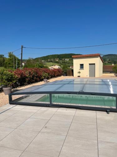 a swimming pool with a glass roof at Gîte de brizolles in Cluny