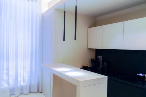 a kitchen with white cabinets and a white counter top at Virginia Madre Luxury Rooms in San Benedetto del Tronto