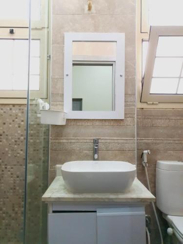 a bathroom with a sink and a mirror at زافيرو محطه الرمل للعائلات فقط - families only in Alexandria