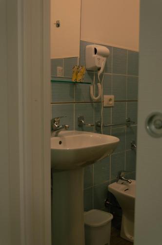 a bathroom with a sink and a toilet at BONORUM De Spuches in Palermo