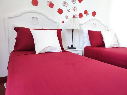a bedroom with two beds with red and white sheets at Spacious 3Bedroom Apartment in Nardò, Apulia, Balcony, AC, Wi-Fi in Nardò