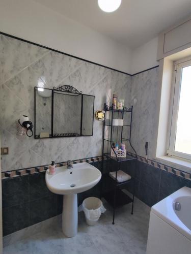 a bathroom with a sink and a mirror at Spacious 3Bedroom Apartment in Nardò, Apulia, Balcony, AC, Wi-Fi in Nardò