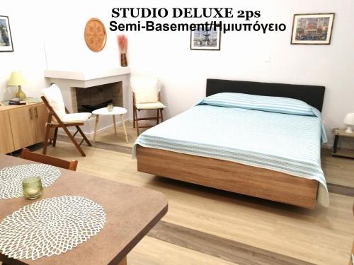 a bedroom with a bed and a dining room at Galini Studios Paralia Platanou in Akrata