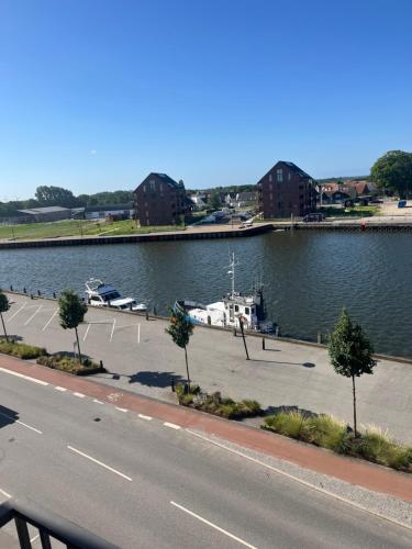 a road next to a body of water with a marina at Lækker lejlighed på havnefronten 1 in Nakskov