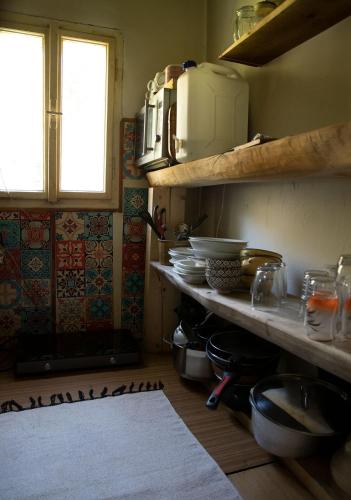 a kitchen with a counter with bowls and plates on it at Chata Na Palouchu in Komorovice
