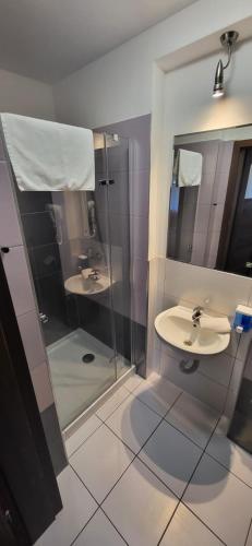 a bathroom with two sinks and a shower at 300 mil in Szklarska Poręba