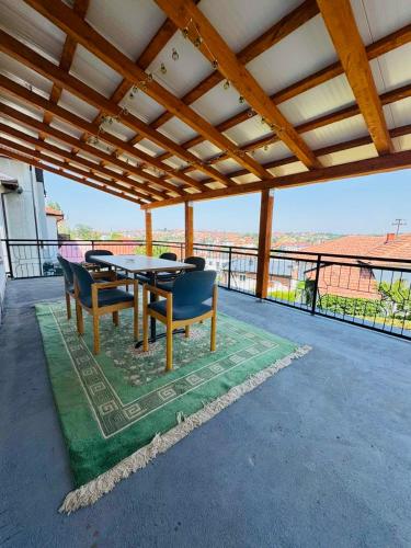 a patio with a table and chairs on a balcony at Old Town Heritage in Gradačac