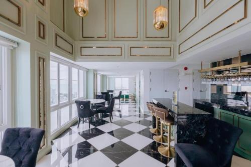 a kitchen with a black and white checkered floor at Skyline Stay - Empire Tower in Jomtien Beach