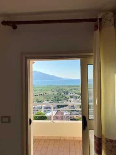 a sliding glass door with a view of a city at Kings Castle Sea View Apartments in Orikum