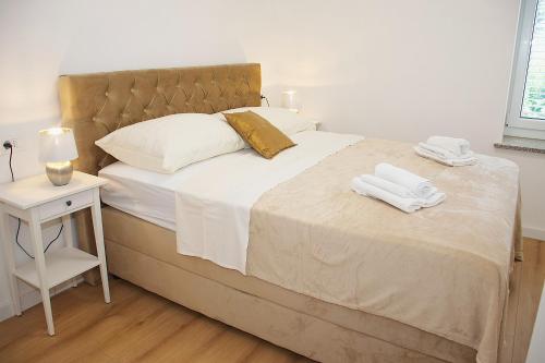 a bedroom with a bed with two towels on it at Tramonto Suite in Novalja