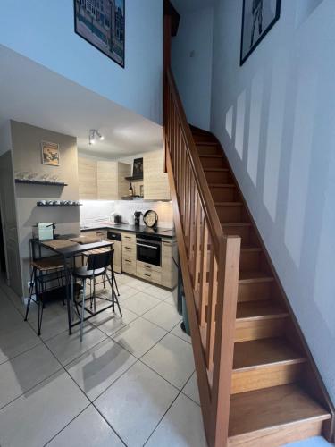 une cuisine et une salle à manger avec un escalier et une table dans l'établissement Appartement duplex la Ciotat, à La Ciotat
