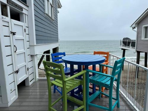 a table and chairs on a balcony with the ocean at Blue Marlin in Hampton