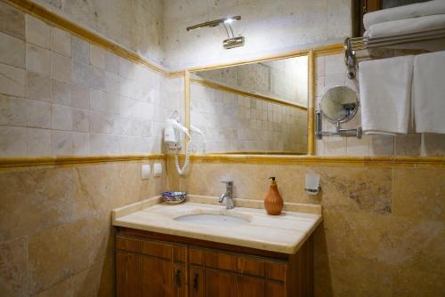a bathroom with a sink and a mirror at Harman Cave Hotel in Goreme