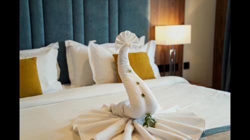 a towel angel on a bed in a hotel room at Rosa Grand Hotel in Riyadh