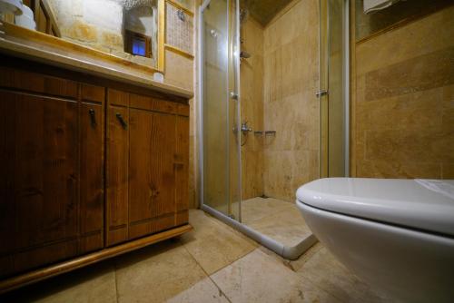 a bathroom with a shower and a sink and a toilet at Harman Cave Hotel in Goreme