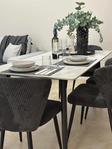 a dining room table with plates and wine glasses at The Lumen in Nea Chili