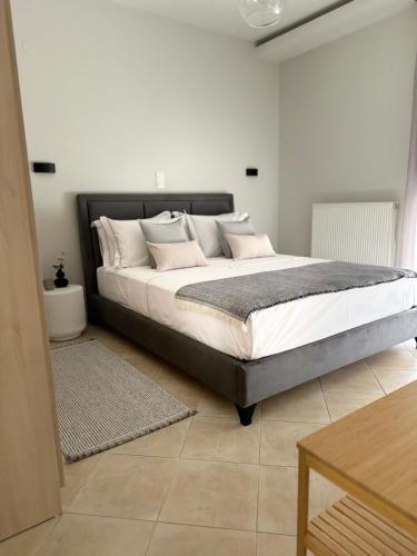 a bedroom with a large bed with pillows on it at The Lumen in Nea Chili