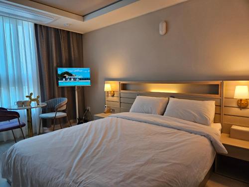a hotel room with a bed and a tv at Daegu StarB&B DSR Hotel mia Guestroom in Daegu