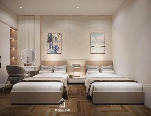 a room with three beds and a desk with a mirror at Tuỳ Tâm Luxury Hotel Quảng Trị in Ðông Hà