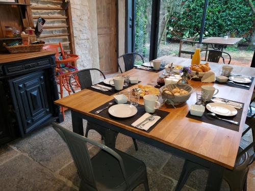 a wooden table with a bunch of food on it at la grange aux hirondelles in Sancoins