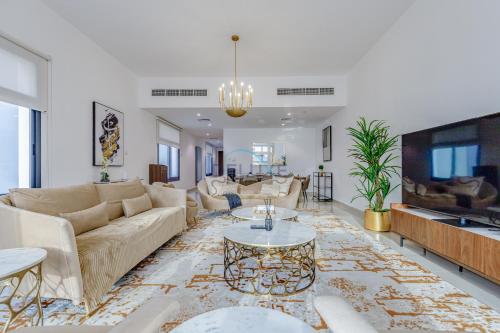 a living room with a couch and a table at Beautiful Villa with Sea Views and Jacuzzi, Near Diving, Paddle Boating and Camping Spots, Sharm Al Dana Villa, Fujairah by Deluxe Holiday Homes in Fujairah