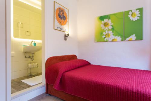 a bedroom with a bed and a bathroom with a sink at Apartments Rudjer in Dubrovnik