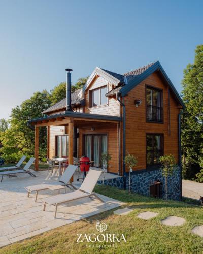 a house with lounge chairs in front of it at Boutique Villa Zagorka in Stubicke Toplice