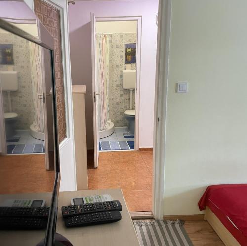 a room with a desk with a computer and a mirror at Red Locomotive Apartment in Budapest