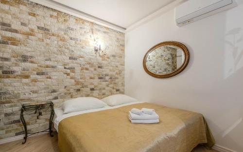 a bedroom with a bed with a brick wall at Willa Ahava in Kazimierz Dolny