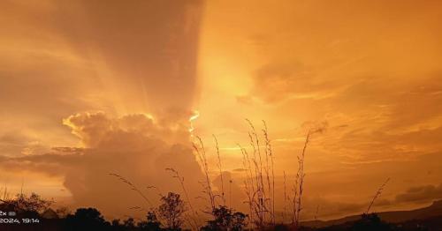 a sunset with the sun in the sky at Maharaja foothills Courtyard 4 BHK Villa with Pool in Kolvan