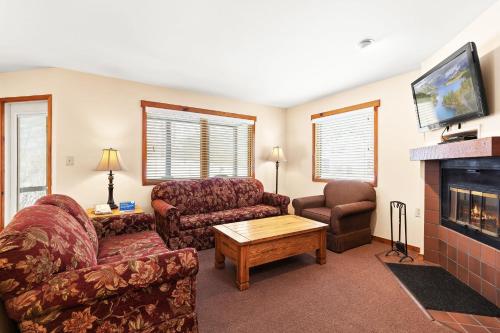 a living room with a couch and a fireplace at Wyndham Shawnee Village 2BR Apartment with Resort Access in East Stroudsburg