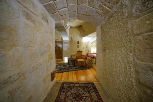 a hallway with a stone wall and a dining room at Harman Cave Hotel in Goreme