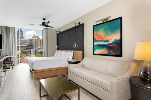 a living room with a bed and a couch at Margaritaville Vacation Club Atlanta Studio Apartment with Resort Access in Atlanta