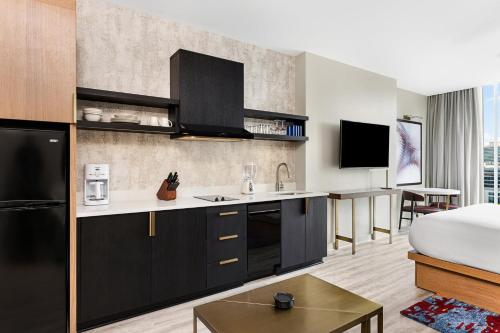a hotel room with a kitchen and a bed at Margaritaville Vacation Club Atlanta Studio Apartment with Resort Access in Atlanta