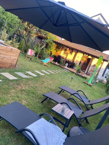 a group of lawn chairs and tables in a yard at Elephant House-Sd 