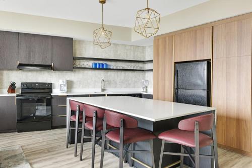 a kitchen with a island with red bar stools at Wyndham Margaritaville Resort 2BR Apartment with Resort Access in Atlanta